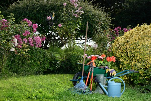 Close-up of a technician using a pressure washer on paving in a Finchley garden